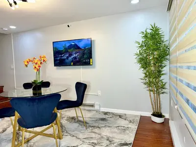 a meeting room with a table and chairs and a plant at BP STAYS - Hotel-Style, No Host, Professionally Managed ID252 in Jersey City