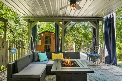 a patio with a couch and a fire pit at Hideaway Hot Tub Sunna Lake Kayaks Pool in Bushkill