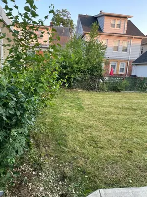 a grassy yard with a house in the background at The Vault in Hillside