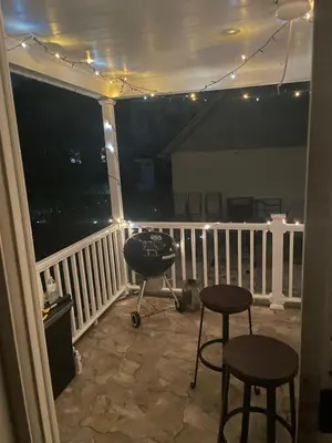 a grill on a balcony at night with lights at The Vault in Hillside