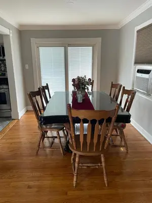 a dining room with a glass table and chairs at The Vault in Hillside