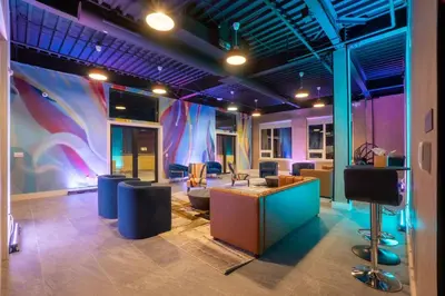 a room with a lobby with chairs and a stage at Bright & Bold+NYC View, Sleep 13, Park 2 cars FREE in East Orange