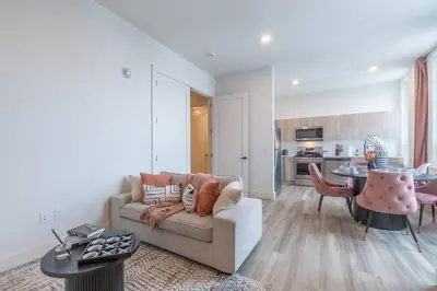 a living room with a couch and a table at Bright & Bold+NYC View, Sleep 13, Park 2 cars FREE in East Orange