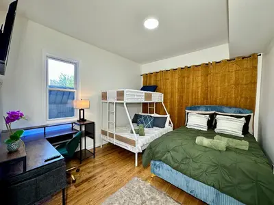 a bedroom with a bed and a desk and a shelf at BP STAYS - Hotel-Style, No Host, Professionally Managed ID255 in Jersey City
