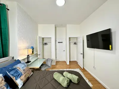 a living room with a couch and a flat screen tv at BP STAYS - Hotel-Style, No Host, Professionally Managed ID255 in Jersey City