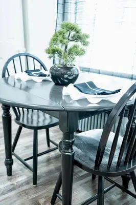 a table with two chairs and a potted plant on it at The Cozy Grey Haven Home - 1st floor in Reading