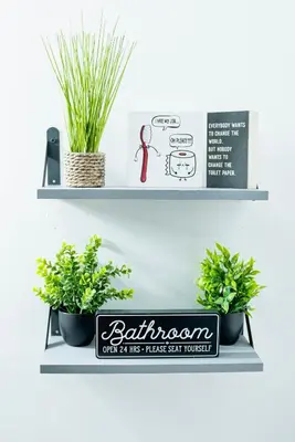 a shelf with two plants and a sign on it at The Cozy Grey Haven Home - 1st floor in Reading