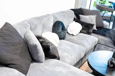 a gray couch with pillows on it in a living room at The Cozy Grey Haven Home - 1st floor in Reading