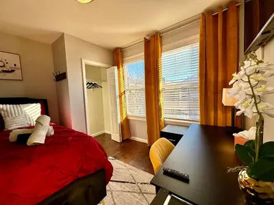 a bedroom with a bed and a desk and a window at Hotel-Style, No Host, Professionally Managed ID267 in Jersey City