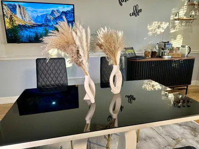 a table with two vases with feathers on it at Hotel-Style, No Host, Professionally Managed ID267 in Jersey City