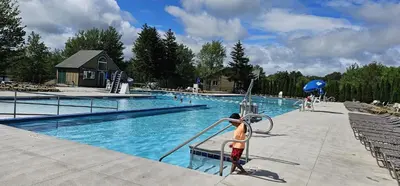 a young boy playing in a swimming pool at Cozy Retreat in Scenic Poconos in Tobyhanna
