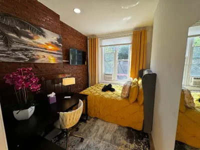 a bedroom with a bed and a desk and a window at BP STAYS - Hotel-Style, No Host, Professionally Managed ID280 in Jersey City