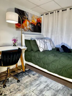 a bedroom with a desk and a green bed and a desk at BP STAYS - Hotel-Style, No Host, Professionally Managed ID280 in Jersey City