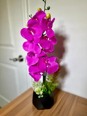 a purple flower in a black vase on a table at BP STAYS - Hotel-Style, No Host, Professionally Managed ID280 in Jersey City