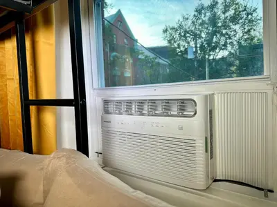 a room with a window with a air conditioner at BP STAYS - Hotel-Style, No Host, Professionally Managed ID280 in Jersey City