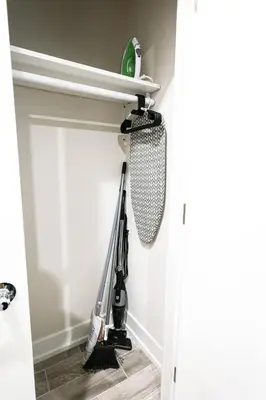a room with a vacuum cleaner hanging on the wall at Perch in Paradise EaglesThemed Escape in Philadelphia
