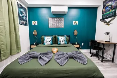 a bedroom with a bed with bows on it at Perch in Paradise EaglesThemed Escape in Philadelphia
