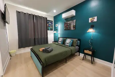 a bedroom with a bed with a blue wall at Fly Eagles Fly StayPhilly Adventure in Philadelphia
