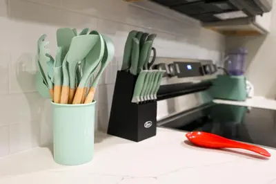 a cup filled with utensils on a kitchen counter at Fly Eagles Fly StayPhilly Adventure in Philadelphia