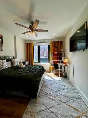 a bedroom with a bed and a flat screen tv at BP STAYS - Hotel-Style, No Host, Professionally Managed ID297 in Jersey City