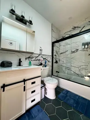 a bathroom with a shower and a toilet and a sink at BP STAYS - Hotel-Style, No Host, Professionally Managed ID297 in Jersey City