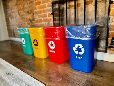 three different colored trash cans sitting on a table at BP STAYS - Hotel-Style, No Host, Professionally Managed ID289 in Jersey City