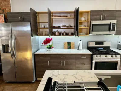 a kitchen with a stainless steel refrigerator and microwave at BP STAYS - Hotel-Style, No Host, Professionally Managed ID289 in Jersey City