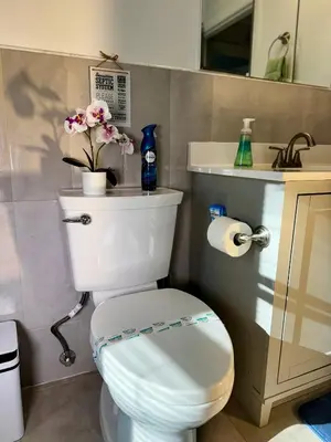 a bathroom with a white toilet and a sink at BP STAYS - Hotel-Style, No Host, Professionally Managed ID289 in Jersey City