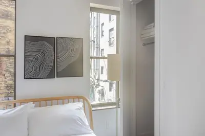 a bedroom with a bed and a window at Blueground Chinatown washer nr City Hall NYC-1871 in New York