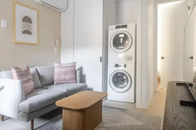 a living room with a couch and a washing machine at Blueground Chinatown washer nr City Hall NYC-1871 in New York