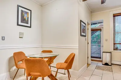 a dining room with a glass table and chairs at Walk to Washington St Hoboken Apt with Balcony! in Hoboken
