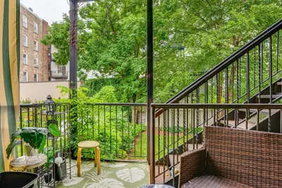 a balcony with a railing and a table and chairs at Walk to Washington St Hoboken Apt with Balcony! in Hoboken