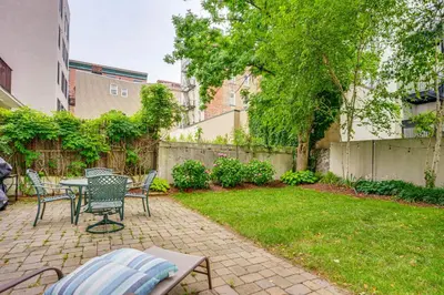 a patio with a table and chairs in a yard at Walk to Washington St Hoboken Apt with Balcony! in Hoboken