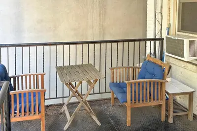 a balcony with chairs and a table and a table and chairs at Walk to Washington St Hoboken Apt with Balcony! in Hoboken