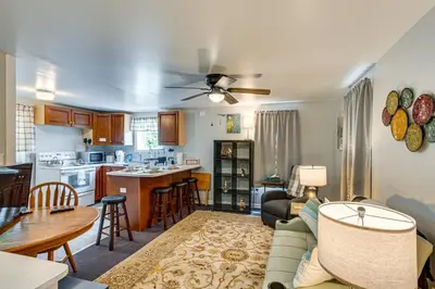 a living room and kitchen with a couch and a table at Honey Bee Farm On-Site Susquehanna Valley Apt! in Dalmatia