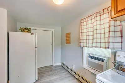 a kitchen with a refrigerator and a window at Honey Bee Farm On-Site Susquehanna Valley Apt! in Dalmatia