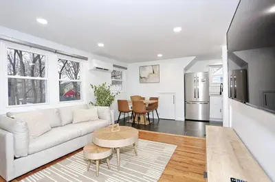 a living room with a couch and a table at NEW Modern NYC Escape near MetLife AmDream MALL EWR in Bergenfield