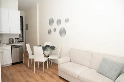 a living room with a white couch and a table at East2 Village Center Apartment7 w Full Amenities Great New York Location in New York