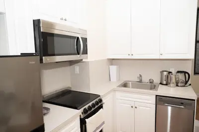 a kitchen with a microwave and a sink at East2 Village Center Apartment7 w Full Amenities Great New York Location in New York