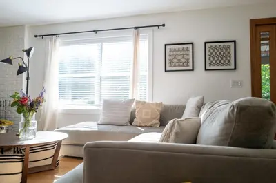 a living room with a couch and a window at Stylish Catskills Escape Near Town & Trails in Livingston Manor