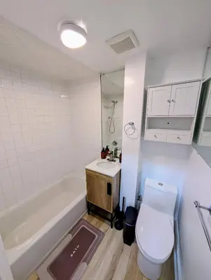 a bathroom with a toilet and a tub and a sink at Central brownstone in Hoboken Dwntn! 15 mins to NY in Hoboken