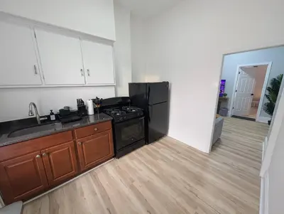 a kitchen with a stove and a refrigerator at Central brownstone in Hoboken Dwntn! 15 mins to NY in Hoboken