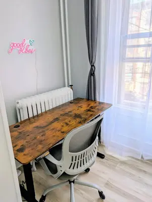 a wooden table with a chair next to a window at Central brownstone in Hoboken Dwntn! 15 mins to NY in Hoboken