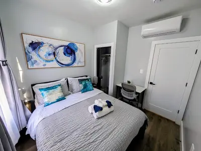 a bedroom with a bed with a stuffed animal on it at Newly Renovated Charming Apt! 30 Mins to Manhattan in Jersey City