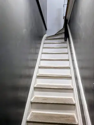 a stair case in a building with escalators at Newly Renovated Charming Apt! 30 Mins to Manhattan in Jersey City