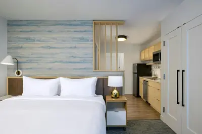 a bedroom with a bed and a kitchen at TownePlace Suites by Marriott Pottsville in Pottsville