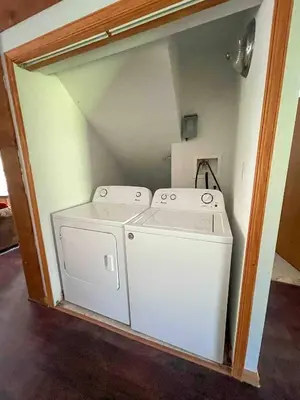 a laundry room with a washer and dryer at 9Br lake fr Volley ball/hot tub in Towamensing Trails