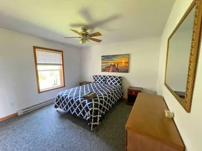 a bedroom with a bed and a ceiling fan at 9Br lake fr Volley ball/hot tub in Towamensing Trails