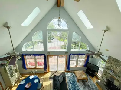 an overhead view of a living room with a large window at 9Br lake fr Volley ball/hot tub in Towamensing Trails