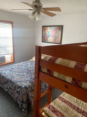 a bedroom with a bed and a ceiling fan at 9Br lake fr Volley ball/hot tub in Towamensing Trails